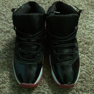 Black,white,red bread Jordan 11s on sale.